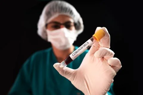 Blood Sample in a flask for analyzing Corona virus and producing vaccine. Corona Stock Photos