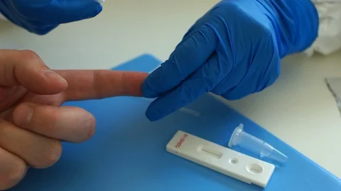 Blood sampling for analysis on coronovirus covid-19. Test cassette for virus Stock Footage 129012169