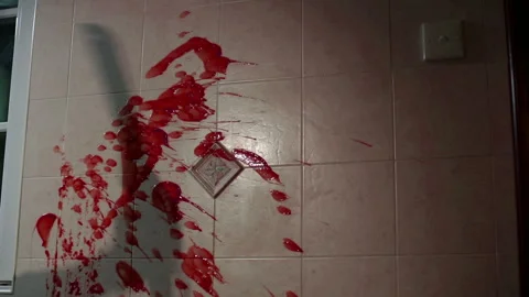 Blood splash on the wall with knife shadow Stock Footage 214459042