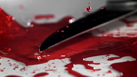 Blood Splatter from a Sharp Metal Knife Hitting a White Glossy Surface 库存影片 331101538