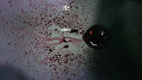Blood splatter washing away down a sink drain Stock Footage 338002229