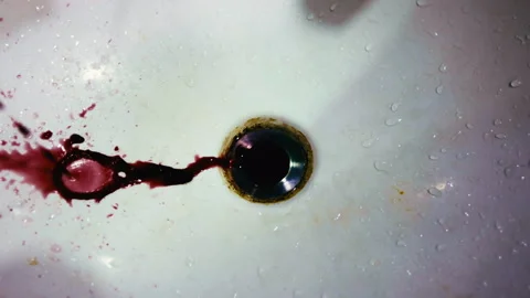 Blood splatter washing down a sink drain Stock Footage 338002292
