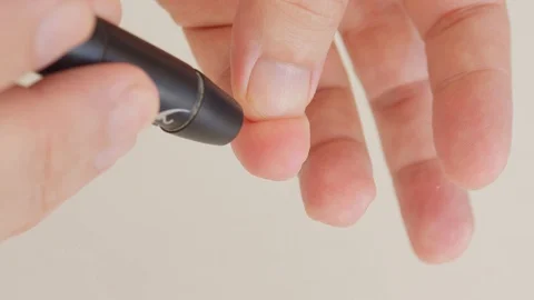 Blood sugar test. Man checking his blood sugar levels. Stock Footage 128130369