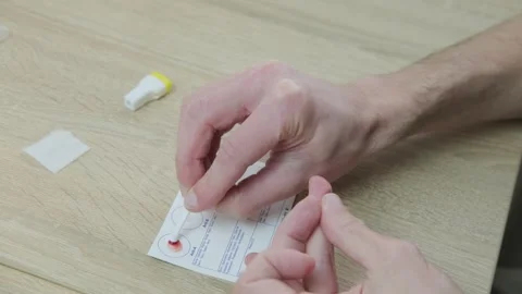 Blood typing test being performed, showing results on card, focusing on hea.. Stock Footage 330123979