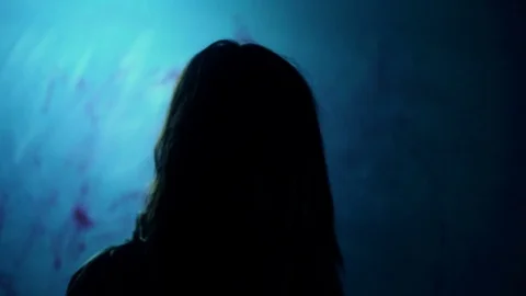 Bloody dark-haired murderer stabbing victim with knife, darkness and horror Stock Footage 71463476