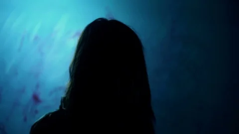 Bloody dark-haired murderer stabbing victim with knife, darkness and horror Stock Footage 71470189