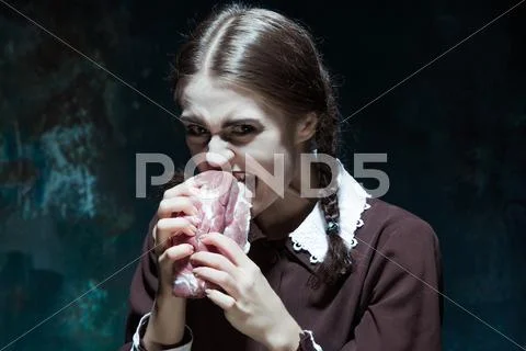 Bloody Halloween theme: crazy girl with raw meat Stock Photos