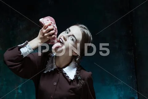Bloody Halloween theme: crazy girl with raw meat Stock Photos