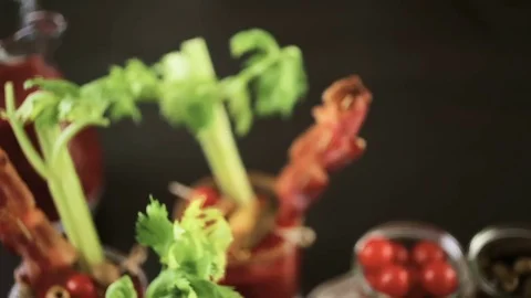Bloody mary cocktail garnished with celery sticks, olives, and bacon strips. Stock Footage