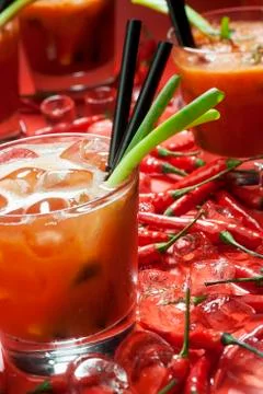 A Bloody Mary, fresh chilli peppers and ice cubes Stock Photos