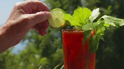 Bloody mary or caesar cocktail with garnish outdoors Stock Footage