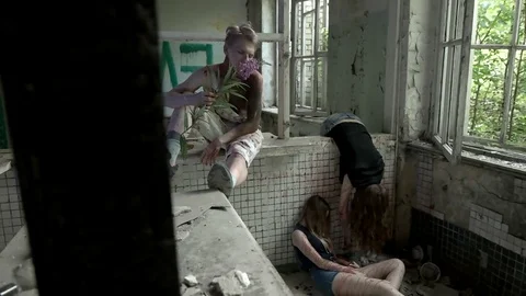 Bloody psychopath sniffs and throws a flower at the dead girls Stock Footage 78205472