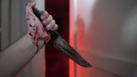 Bloody sharp knife in trembling hand of frightened victim, person with cold Stockbeeldmateriaal 171946567