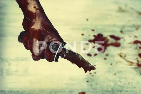 Bloody stabbing. Hand with knife knife, horror blood. Edged weapons in the ha Stock Photos