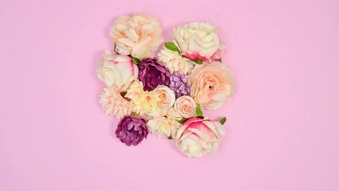 Bloom spring flowers make heart shape on pastel pink theme. Stop motion Stock Footage 166370970