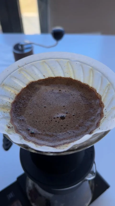 Blooming coffee grounds during the pour-over brewing process Stock Footage 297373615
