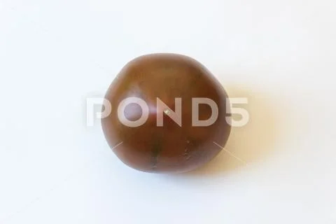 Blossom end view of a deep red green Cherokee Purple organic heirloom tomato Stock Photos