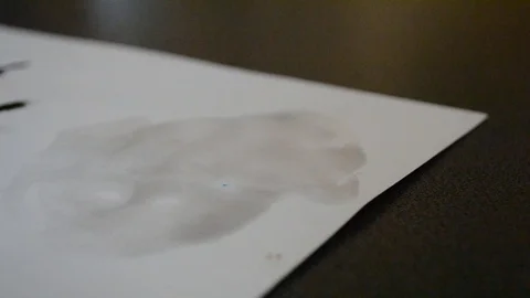 Blot from the ink left by a brush on white paper. Stock Footage 91078324
