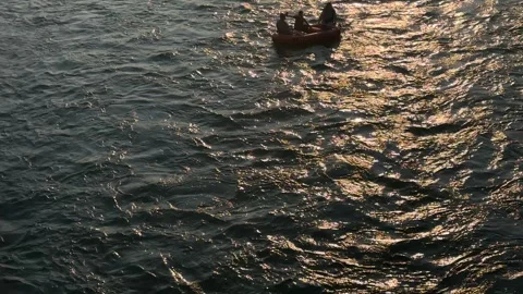 Blow up boat with people floating down the river summer evening, backlit close Stock-Footage 345143267
