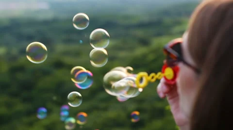 Blow bubbles Stock Footage 64935437