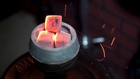 Blow the coals for hookah Stock Footage 99957970