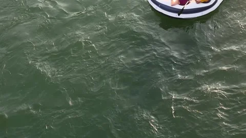 Blow up float with people floating down the river summer evening, close up Stock-Footage 345143257