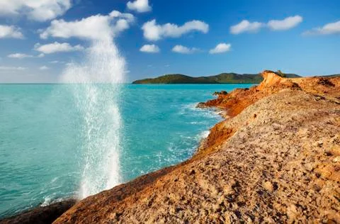 A blow hole produced by waves running into a crevice at Stony Horn, Antigua. Stock Photos