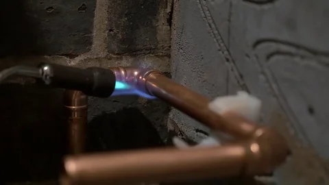 Blow torch brazing solder on copper water pipe elbow fittings England May 2017 Stock-Footage 82005538