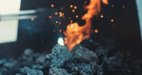 Blow torch lighting coal in a forge Stock Footage 105296478