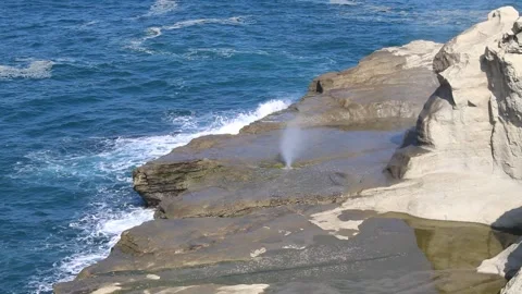 Blowhole in the middle of sea stack Stock Footage 294852174