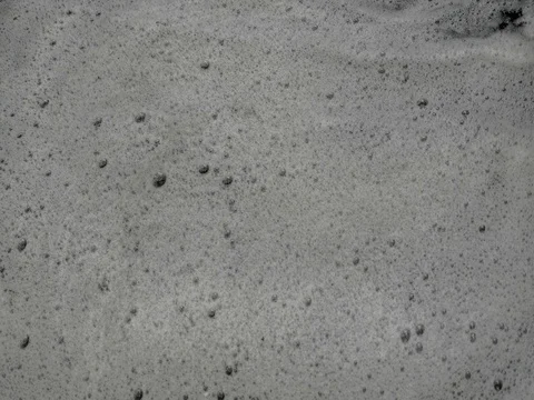 Blowing and spinning foam in stream of small stream, pollution. 스톡 동영상 75167779