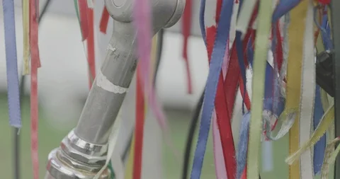 Blowing and winding various decorated ribbons on handlebar of bicycle. Stock Footage 116205580
