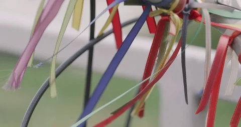 Blowing and winding various decorated ribbons on handlebar of bicycle. Video stock 116205585