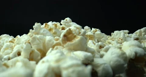 Blowing away popcorn from table. Close-up of popcorn. Popcorn texture background Stock Footage 142983722