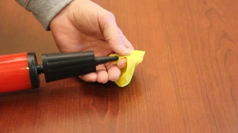 Blowing up balloon with a hand pump Stock Footage 21811891