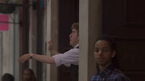 Blowing Bubbles and conducting unseen orchestra in busy city street. Stock Footage 93205941