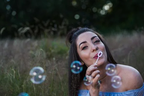 Blowing bubbles in a meadow Stock Photos
