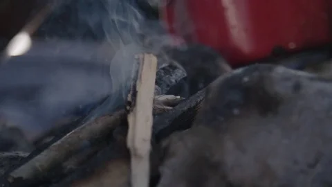 Blowing into Campfire Stockbeeldmateriaal 76558118