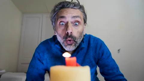 Blowing candle man Stock Photos