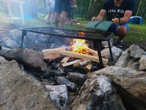 Blowing up the fire in the camp in the nature Stock Footage 246581585