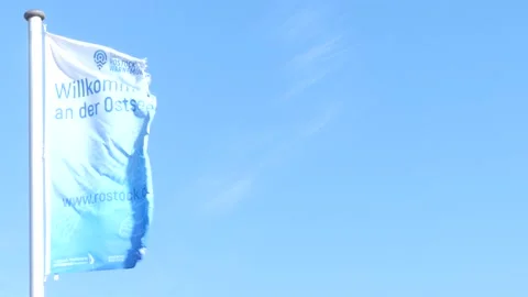 Blowing flag with german writing : 'welcome to the baltic sea' - Rostock Stock Footage 138613697