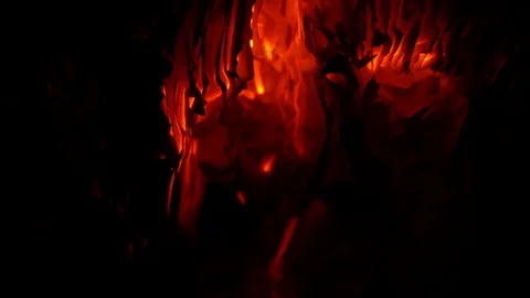 Blowing on glowing paper on black background Stock Footage 128206349