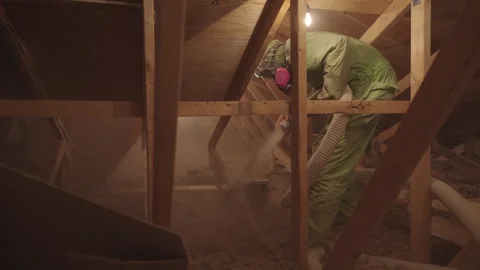Blowing in Loose Cellulose Insulation in to Home Attic Weatherization Stock Footage 340923559
