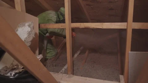 Blowing in Loose Cellulose Insulation in to Home Attic Weatherization Stock Footage 340923586