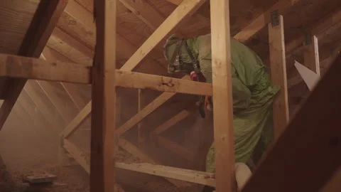 Blowing in Loose Cellulose Insulation in to Home Attic Weatherization Stock Footage 340923635