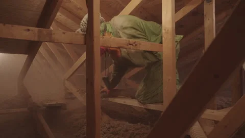 Blowing in Loose Cellulose Insulation in to Home Attic Weatherization Stock Footage 340923662