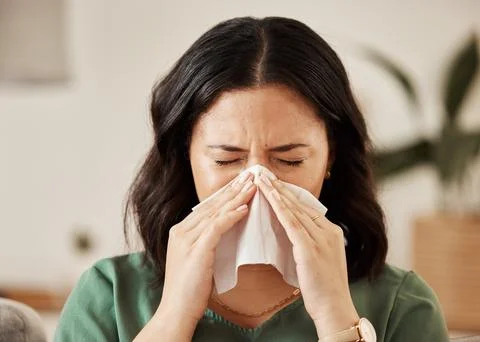 Blowing nose, tissue and woman in a living room with flu, cold and hay fever Stock Photos