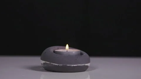 Blowing out a candle with black background in slow motion Stock Footage 58761314