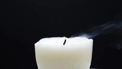 Blowing out candle in slow motion isolated on black Stock Footage 169898241