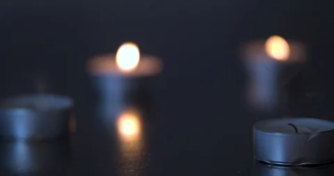 Blowing out Candles on a Black Table Stock Footage 101372914